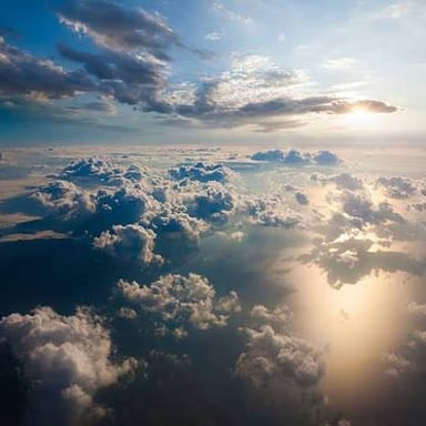 White clouds spread across the sky above a landscape.