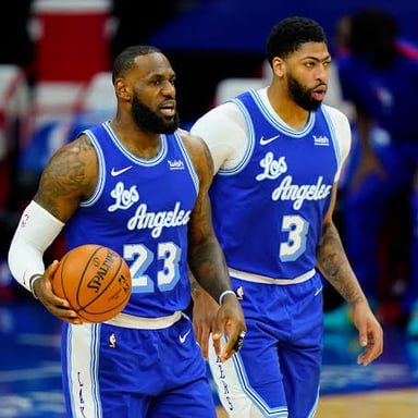 Los Angeles Lakers players in purple and gold uniforms during a basketball game.