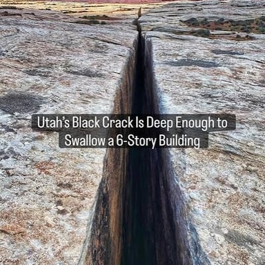 A deep chasm dropping steeply between rocky sides.