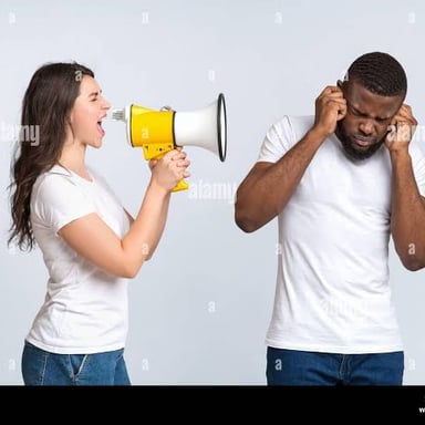 A person raising their voice to be heard above surrounding noise.