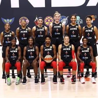 Players from the Las Vegas Aces basketball team on a court.