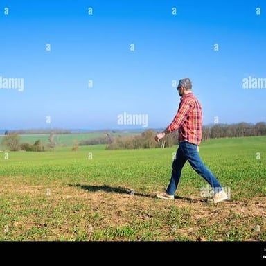 A person walking through a wide open landscape