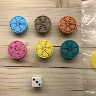 A colorful wedge-shaped Trivial Pursuit playing piece.