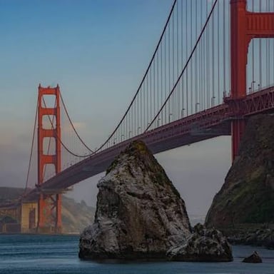 The orange Golden Gate Bridge stretches across the strait at the entrance to San Francisco Bay.