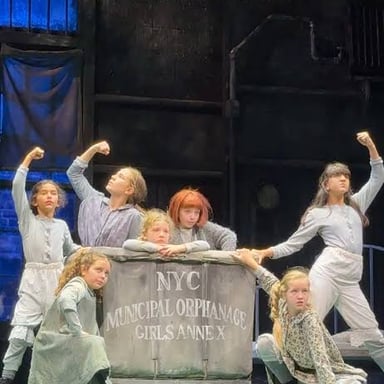 A performance scene from the musical Annie