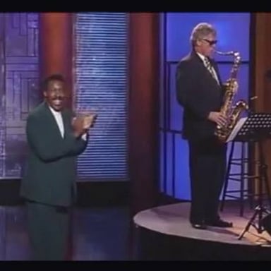 Bill Clinton playing a saxophone during a late-night television appearance.