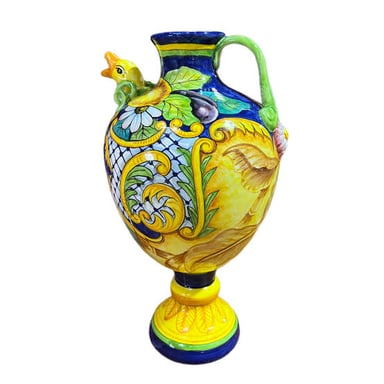A decorated ceramic urn with a rounded body and handles.