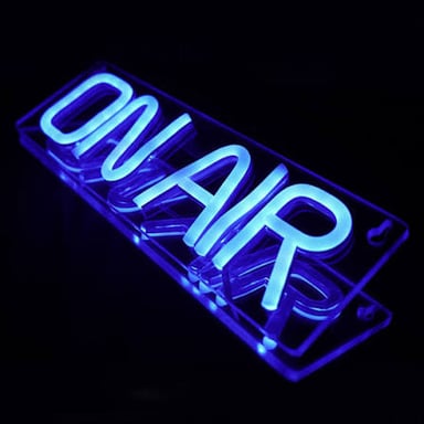 An illuminated ON AIR sign in a broadcast studio.