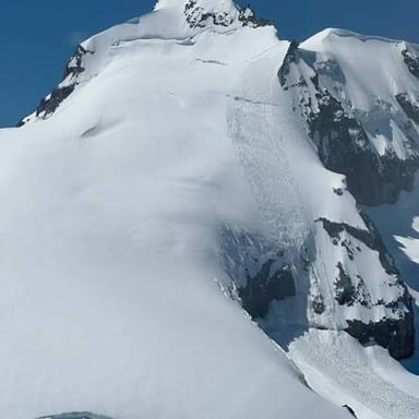 A thick layer of snow forming a snowpack on a mountain slope
