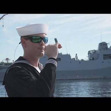 A sailor responding to a captain aboard a ship.
