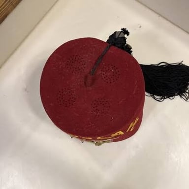 A red fez with a black tassel.