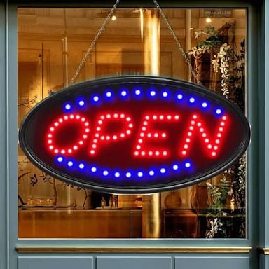 An OPEN sign displayed in a shop window.