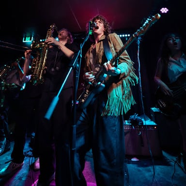 A funk band performing with a strong rhythmic feel