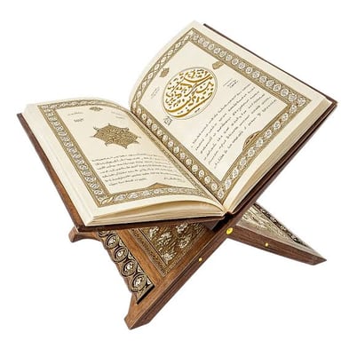An open copy of the Quran with Arabic calligraphy on its pages.