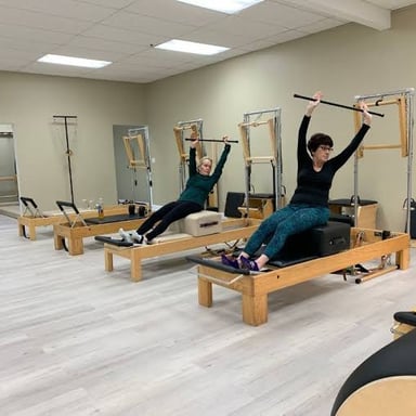 A person stretching after exercise and experiencing muscle soreness.