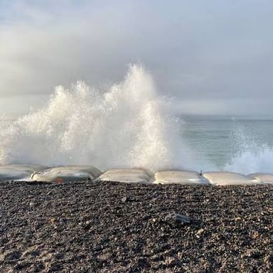 The sea receding from a shoreline during an ebb tide.