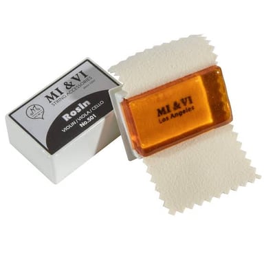 A violin bow beside a small cake of rosin.