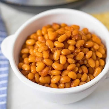A bowl of baked beans in sauce