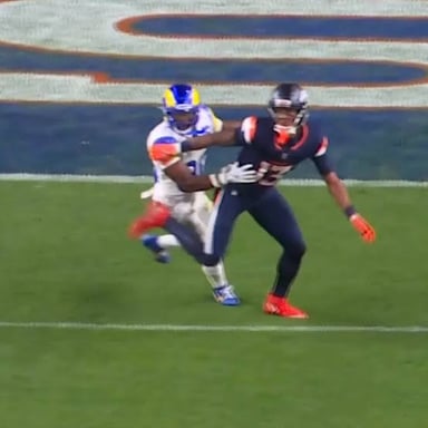 A defensive football player catches a pass intended for an opponent.