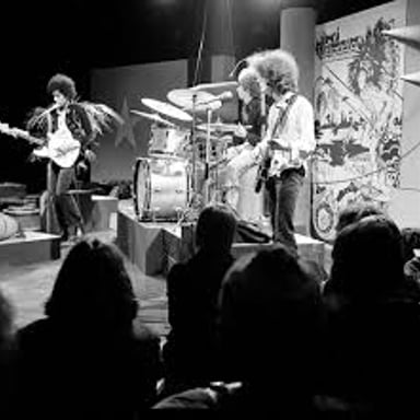 Musicians performing rock and roll with electric guitar and drums.