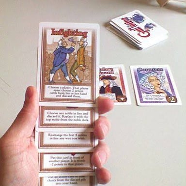 Hands moving playing cards into a different order.