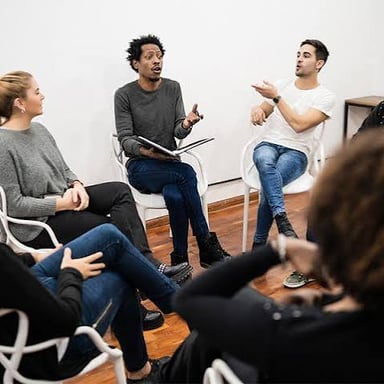 A person speaking confidently during a group discussion.