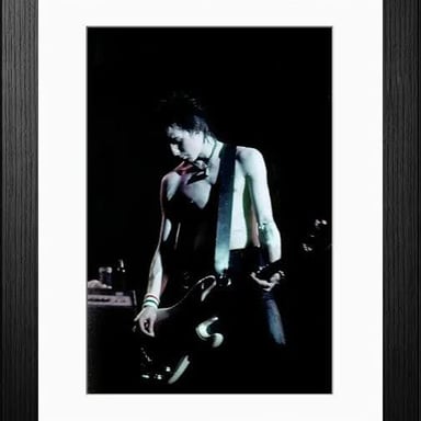 A performance photograph of punk musician Sid Vicious.