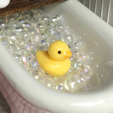 A yellow rubber duck floating in a bathtub