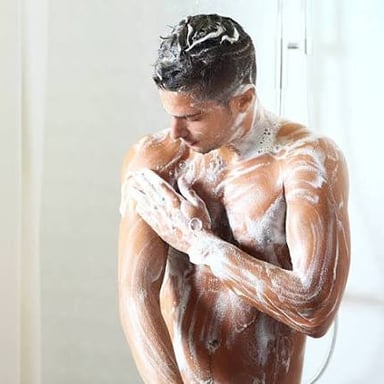 A person covered in white soap lather