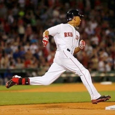 A baseball runner stands on first base.