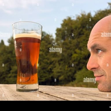 A person sipping beer from a glass.