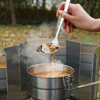 A ladle scooping soup from a pot