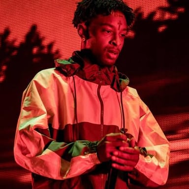 Rappers 21 Savage and 50 Cent performing onstage.