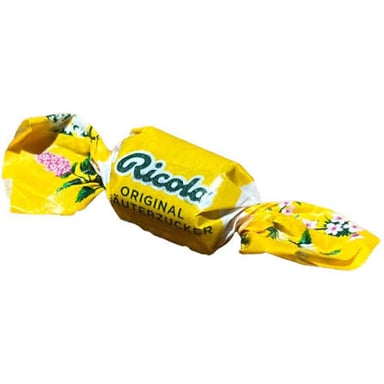 A medicated cough lozenge beside its wrapper