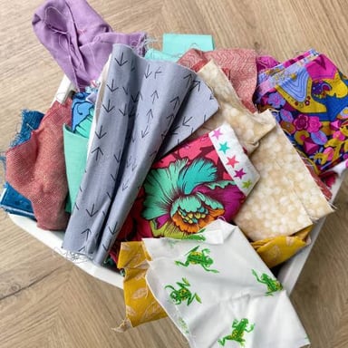 Several small leftover pieces of colorful fabric.