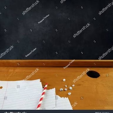 A small wad of paper and a straw suggest the classroom prank called a spitball.