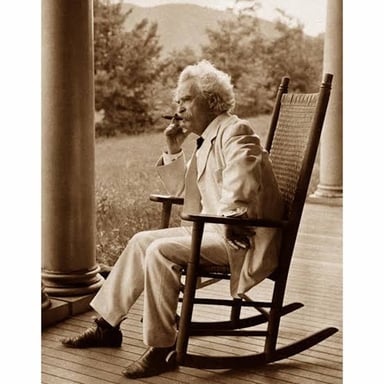 A portrait of Mark Twain holding or smoking a cigar.
