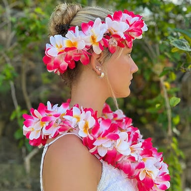 A colorful flower garland worn around a person’s neck.