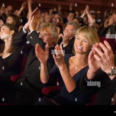 An audience applauding with raised hands.