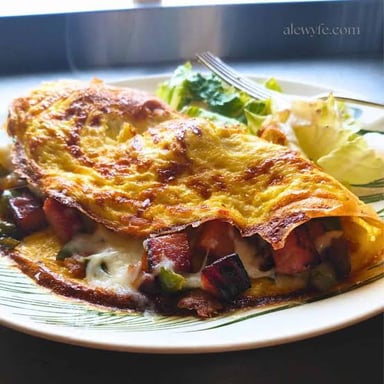 A Denver omelet made with ham, peppers, and onions.