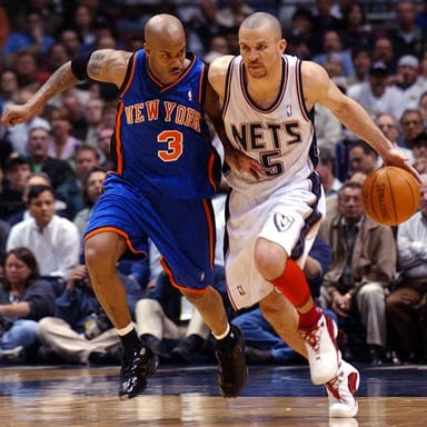 Players from the Brooklyn Nets and New York Knicks competing in a basketball game.
