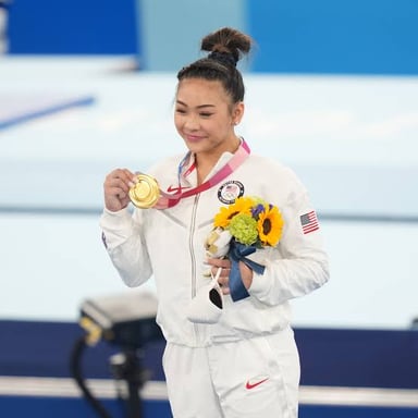 Sunisa Lee competing as an Olympic gymnast.