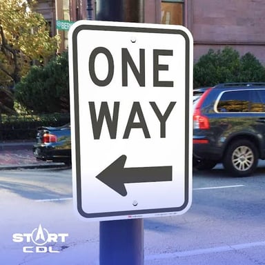 A road marked with a one-way traffic sign