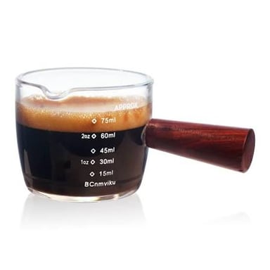 A small cup holding a serving of espresso.