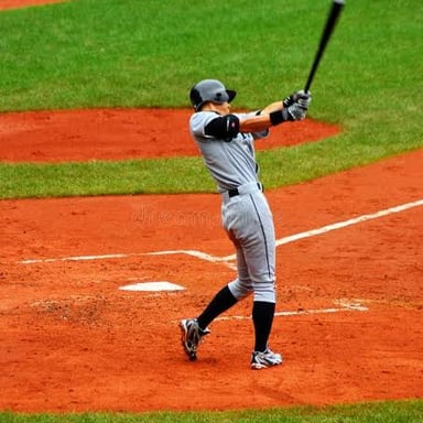 A baseball batter takes a position at home plate.