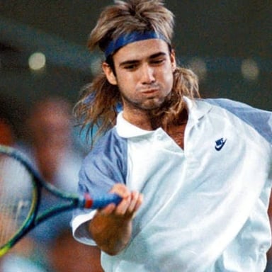 Andre Agassi playing tennis in competition.