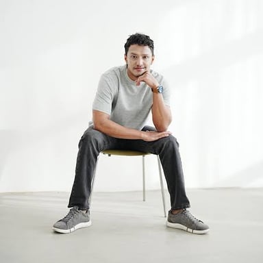 A person standing in a relaxed, casual pose.