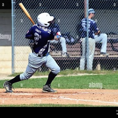 A baseball batter hitting while a runner scores.