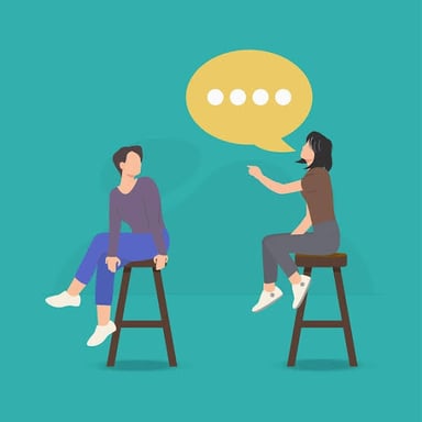 One person listens expectantly as another speaks.