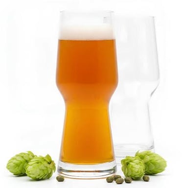 A glass of India pale ale beside green hop cones, the ingredient that gives the beer its characteristic bitterness and aroma.